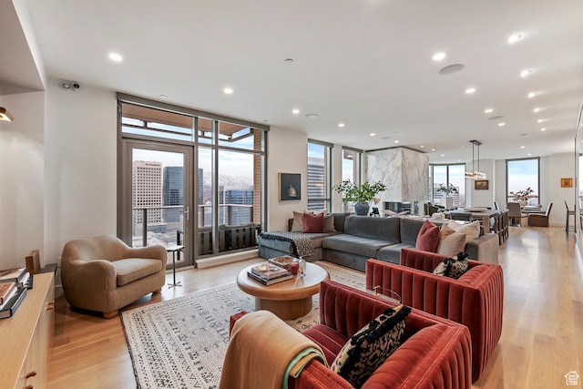 living room featuring light hardwood / wood-style floors and a wall of windows