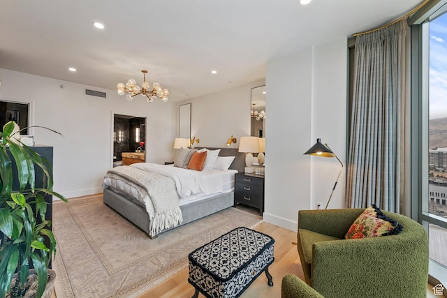 99 W S Temple St S Unit 2201, Salt Lake City, UT 84101 - bedroom featuring a notable chandelier and light hardwood / wood-style flooring
