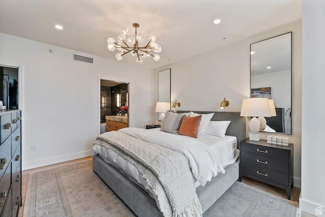 99 W S Temple St S Unit 2201, Salt Lake City, UT 84101 - bedroom featuring light wood-type flooring, a chandelier, and ensuite bath