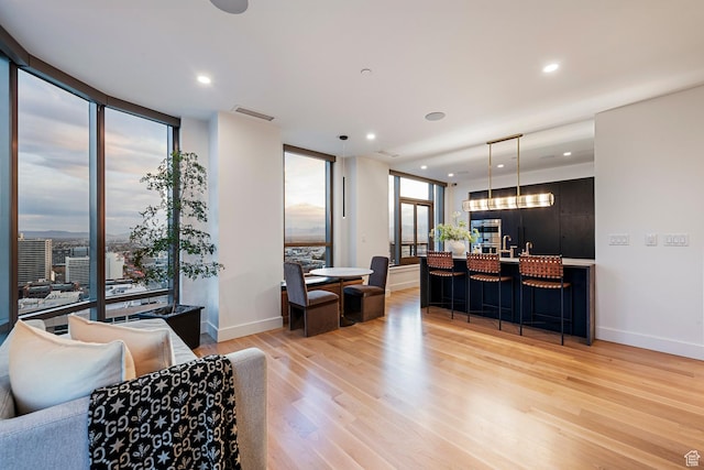 99 W S Temple St S Unit 2201, Salt Lake City, UT 84101 - living room featuring a wall of windows and light hardwood / wood-style flooring