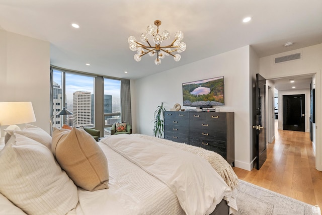 99 W S Temple St S Unit 2201, Salt Lake City, UT 84101 - bedroom with a notable chandelier and light hardwood / wood-style flooring
