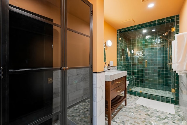 99 W S Temple St S Unit 2201, Salt Lake City, UT 84101 - bathroom featuring tile walls, a shower with shower door, and vanity