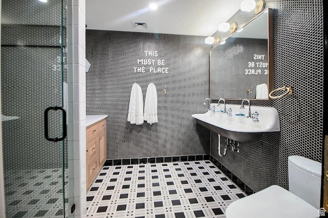 99 W S Temple St S Unit 2201, Salt Lake City, UT 84101 - bathroom featuring tile walls, sink, toilet, and a shower with shower door
