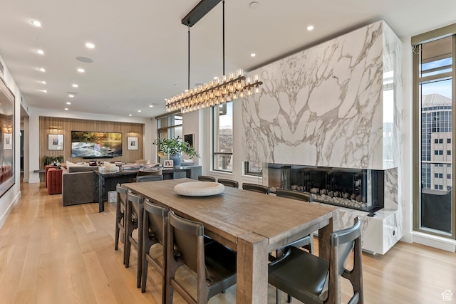 99 W S Temple St S Unit 2201, Salt Lake City, UT 84101 - dining space featuring a high end fireplace, plenty of natural light, and light hardwood / wood-style floors