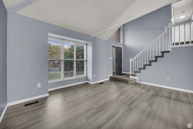 2152 E 3325 N, Layton, UT 84040 - unfurnished living room with high vaulted ceiling, stairs, baseboards, wood finished floors, and visible vents