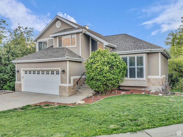 2152 E 3325 N, Layton, UT 84040 - view of front of home with a front lawn, stucco siding, brick siding, a shingled roof, and driveway