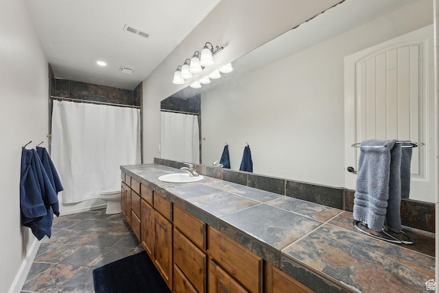 13299 S Laurel Park Ln, Draper, UT 84020 - full bath featuring vanity, visible vents, curtained shower, toilet, and stone finish floor