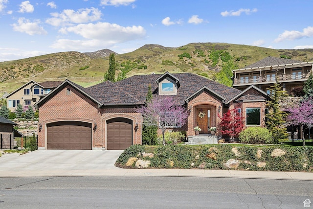 13299 S Laurel Park Ln, Draper, UT 84020 - view of front of house featuring a mountain view, an attached garage, concrete driveway, and brick siding