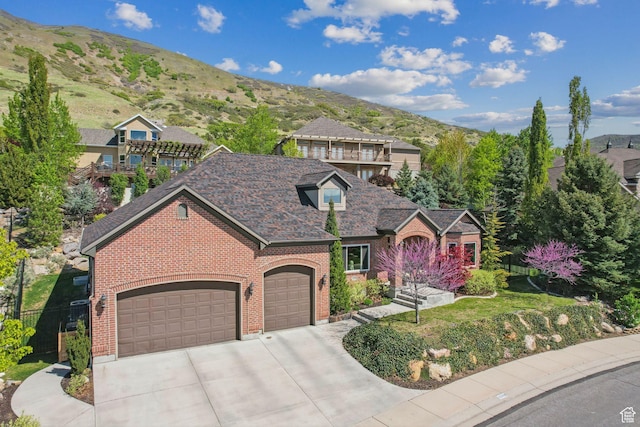 13299 S Laurel Park Ln, Draper, UT 84020 - view of front facade featuring a garage, a mountain view, concrete driveway, and brick siding