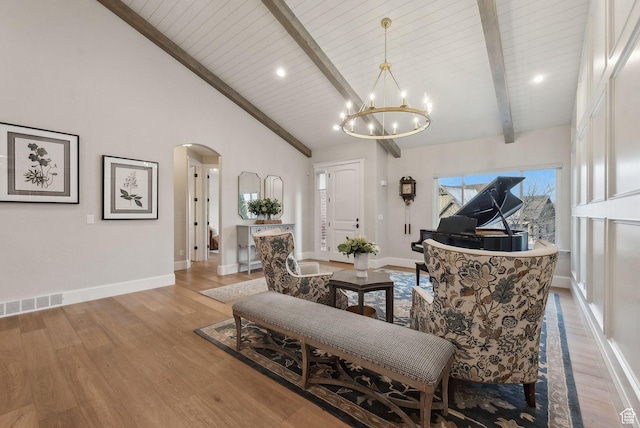 13299 S Laurel Park Ln, Draper, UT 84020 - living room featuring arched walkways, wood finished floors, beam ceiling, baseboards, and a chandelier