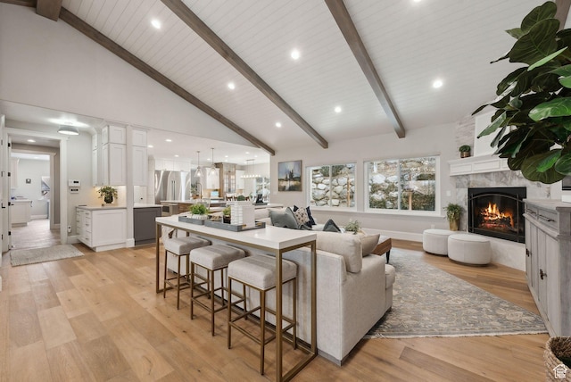 13299 S Laurel Park Ln, Draper, UT 84020 - living area featuring beamed ceiling, a large fireplace, light wood finished floors, and high vaulted ceiling