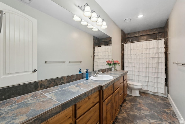 13299 S Laurel Park Ln, Draper, UT 84020 - bathroom featuring stone finish floor, visible vents, baseboards, vanity, and toilet