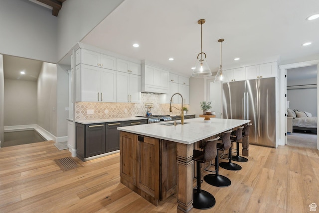 13299 S Laurel Park Ln, Draper, UT 84020 - kitchen with freestanding refrigerator, recessed lighting, tasteful backsplash, a sink, and light wood-style flooring