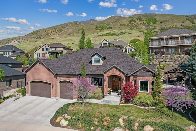 13299 S Laurel Park Ln, Draper, UT 84020 - view of front facade featuring driveway, a residential view, brick siding, a mountain view, and an attached garage