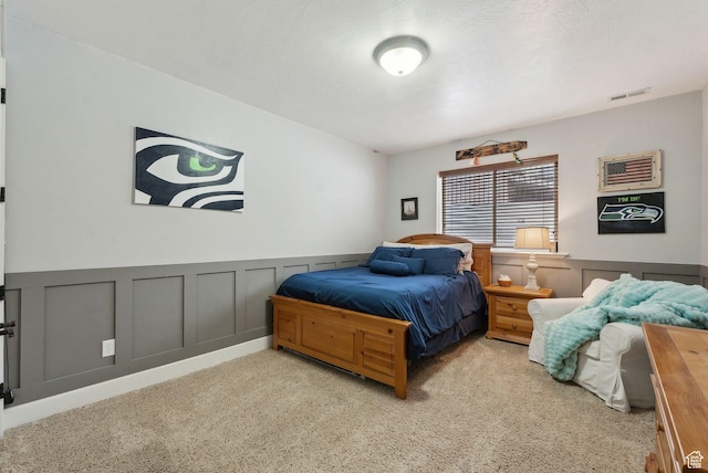 13299 S Laurel Park Ln, Draper, UT 84020 - carpeted bedroom featuring visible vents, wainscoting, and a decorative wall