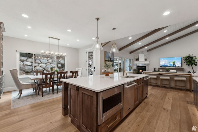 13299 S Laurel Park Ln, Draper, UT 84020 - kitchen with a sink, light countertops, open floor plan, light wood-style floors, and recessed lighting