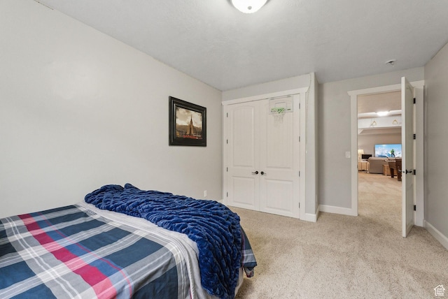 13299 S Laurel Park Ln, Draper, UT 84020 - bedroom featuring baseboards, light carpet, and a closet