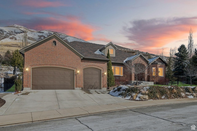 13299 S Laurel Park Ln, Draper, UT 84020 - view of front facade featuring fence, brick siding, a garage, a mountain view, and driveway