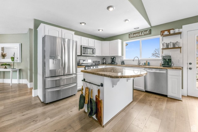 888 W Vahe St S, Draper, UT 84020 - kitchen featuring white cabinets, backsplash, appliances with stainless steel finishes, and dark stone counters