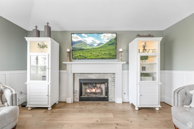 888 W Vahe St S, Draper, UT 84020 - living area with wainscoting, a warm lit fireplace, and wood finished floors