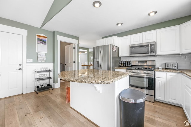 888 W Vahe St S, Draper, UT 84020 - kitchen featuring white cabinets, appliances with stainless steel finishes, and a center island