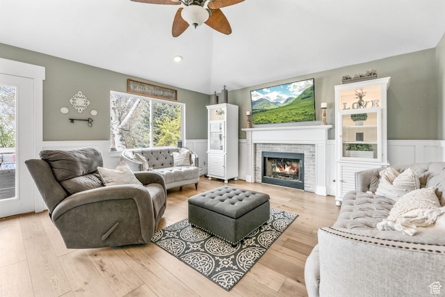 888 W Vahe St S, Draper, UT 84020 - living room with ceiling fan, a wainscoted wall, a brick fireplace, and plenty of natural light