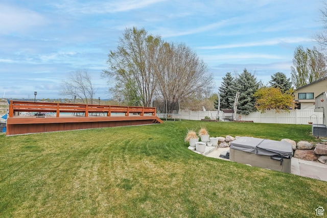 888 W Vahe St S, Draper, UT 84020 - view of yard featuring a fenced backyard, a deck, a hot tub, and a trampoline