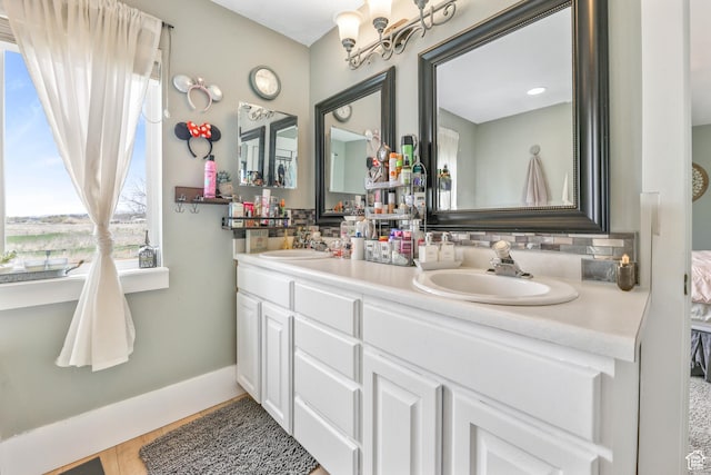 888 W Vahe St S, Draper, UT 84020 - full bathroom with baseboards, tasteful backsplash, a sink, and double vanity