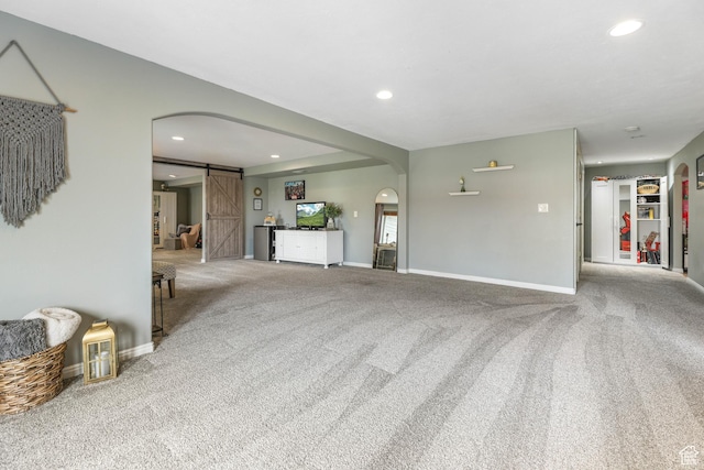 888 W Vahe St S, Draper, UT 84020 - unfurnished living room with a barn door, arched walkways, carpet flooring, and recessed lighting