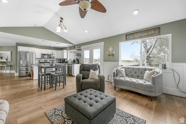 888 W Vahe St S, Draper, UT 84020 - living area featuring vaulted ceiling, a ceiling fan, light wood-style floors, a decorative wall, and wainscoting