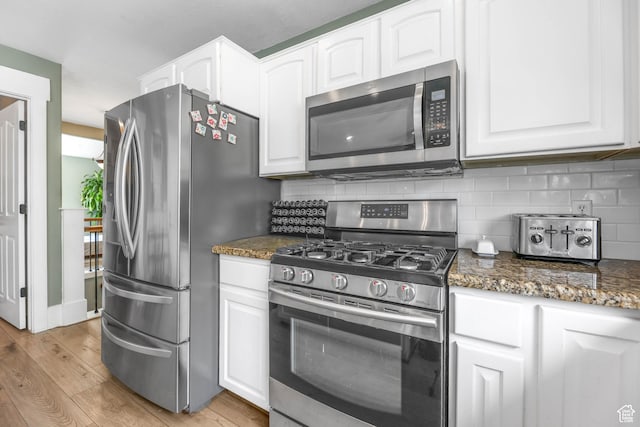 888 W Vahe St S, Draper, UT 84020 - kitchen featuring appliances with stainless steel finishes, white cabinetry, and light wood-style flooring