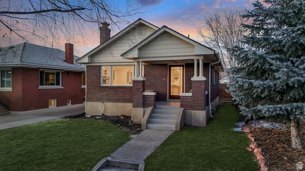 bungalow-style house featuring a yard