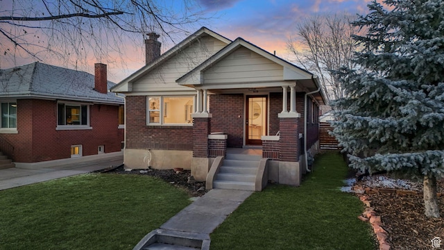 bungalow-style house featuring a yard