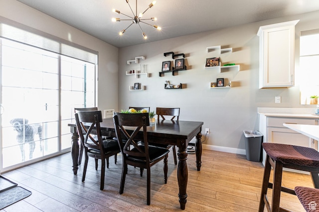1038 W Regatta Ln, Stansbury Park, UT 84074 - dining area featuring a chandelier and light wood-type flooring