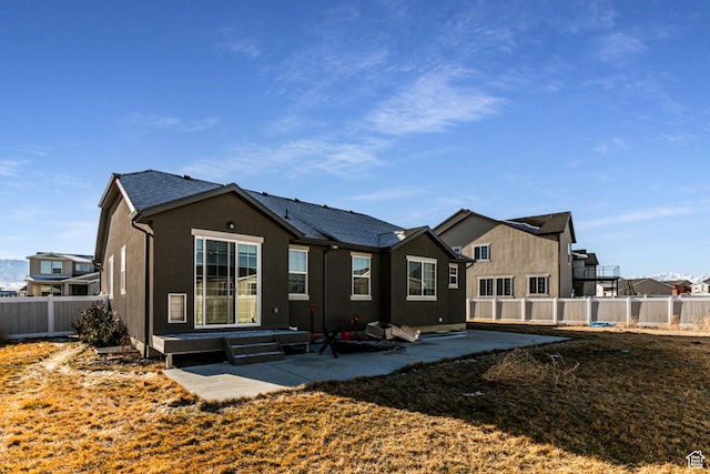 1038 W Regatta Ln, Stansbury Park, UT 84074 - back of house with a patio area
