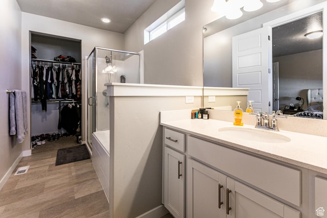 1038 W Regatta Ln, Stansbury Park, UT 84074 - bathroom with vanity, a shower with door, and hardwood / wood-style floors