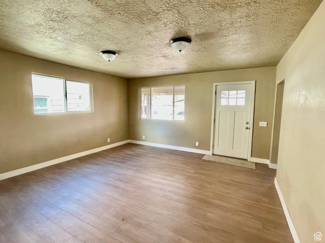 255 W Main St, Mount Pleasant, UT 84647 - entrance foyer featuring wood finished floors, healthy amount of natural light, and a textured ceiling