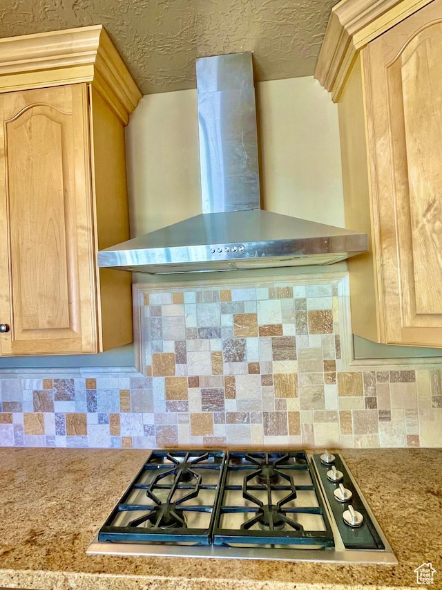 255 W Main St, Mount Pleasant, UT 84647 - kitchen view of wall chimney range hood, light brown cabinetry, stainless steel gas stovetop, and backsplash