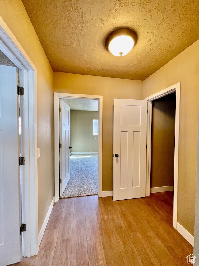 255 W Main St, Mount Pleasant, UT 84647 - hallway featuring wood finished floors and a textured ceiling