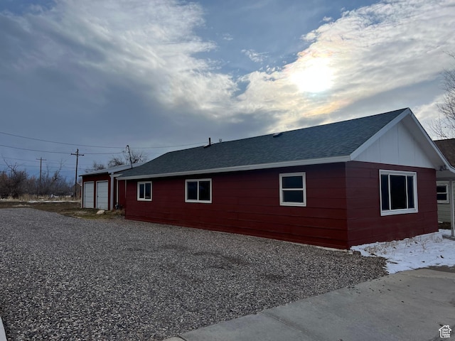 255 W Main St, Mount Pleasant, UT 84647 - view of property exterior with a shingled roof, gravel driveway, and a garage