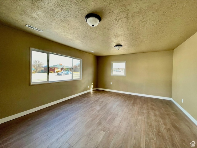 255 W Main St, Mount Pleasant, UT 84647 - empty room with wood finished floors and a textured ceiling