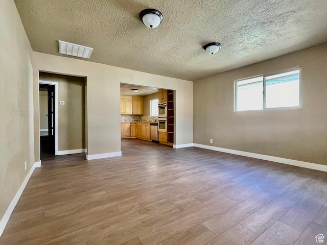 255 W Main St, Mount Pleasant, UT 84647 - unfurnished living room with dark wood-style flooring and a textured ceiling