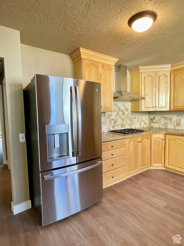 255 W Main St, Mount Pleasant, UT 84647 - kitchen featuring stainless steel appliances, wall chimney exhaust hood, light brown cabinets, wood finished floors, and a textured ceiling