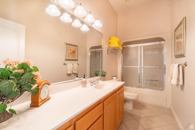full bathroom with tile patterned flooring, vanity, shower / bath combination with glass door, and toilet