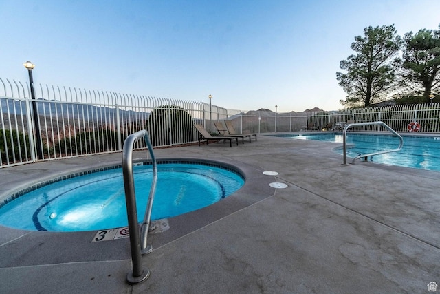 view of pool with a hot tub