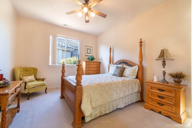 bedroom featuring light carpet and ceiling fan