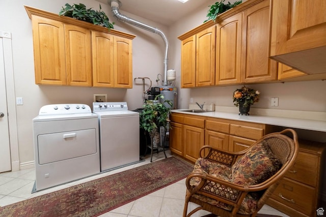 laundry area featuring cabinets, sink, washer and dryer, and light tile patterned floors