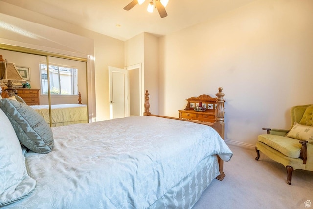carpeted bedroom featuring ceiling fan and a closet