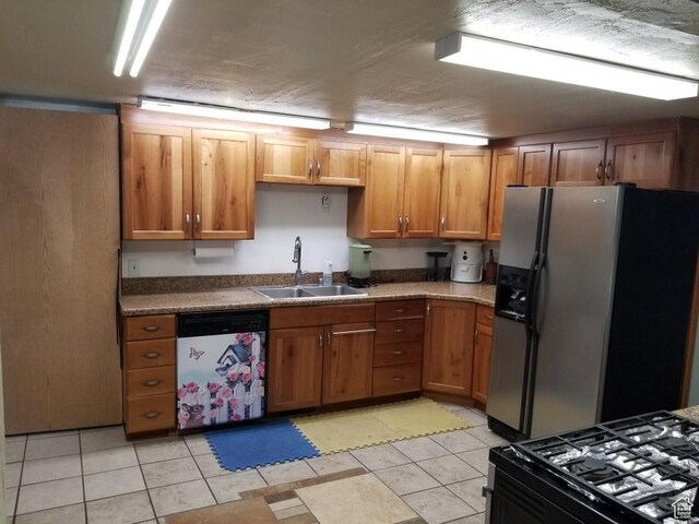 7455 N Capitol Hill Rd, Preston, ID 83263 - kitchen with a sink, brown cabinetry, stainless steel fridge, black gas range, and dishwashing machine