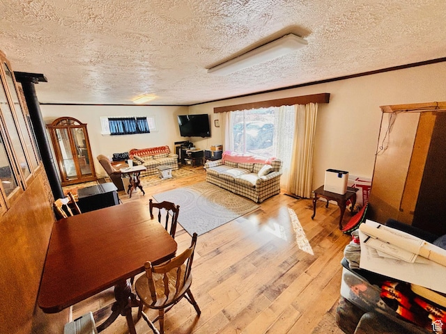 7455 N Capitol Hill Rd, Preston, ID 83263 - living room with ornamental molding, a textured ceiling, and light wood finished floors